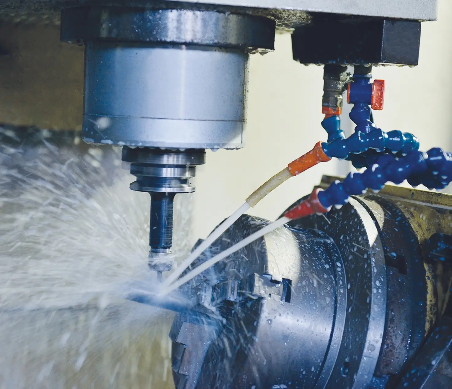 CNC milling machine cutting metal with coolant spray