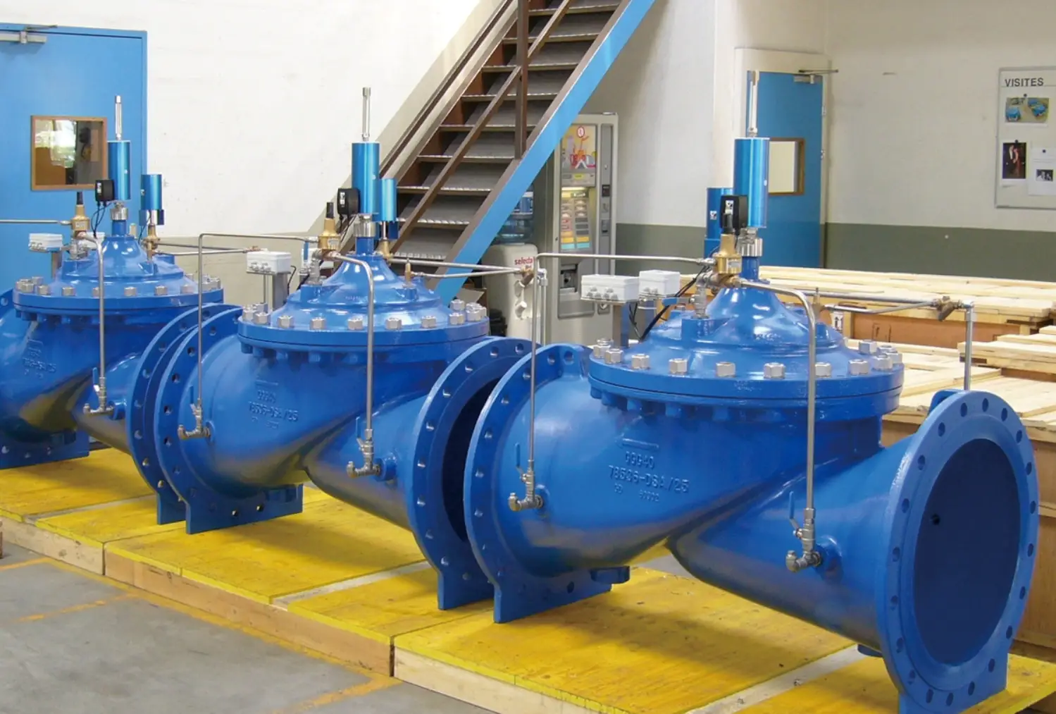 blue industrial control valves with piping