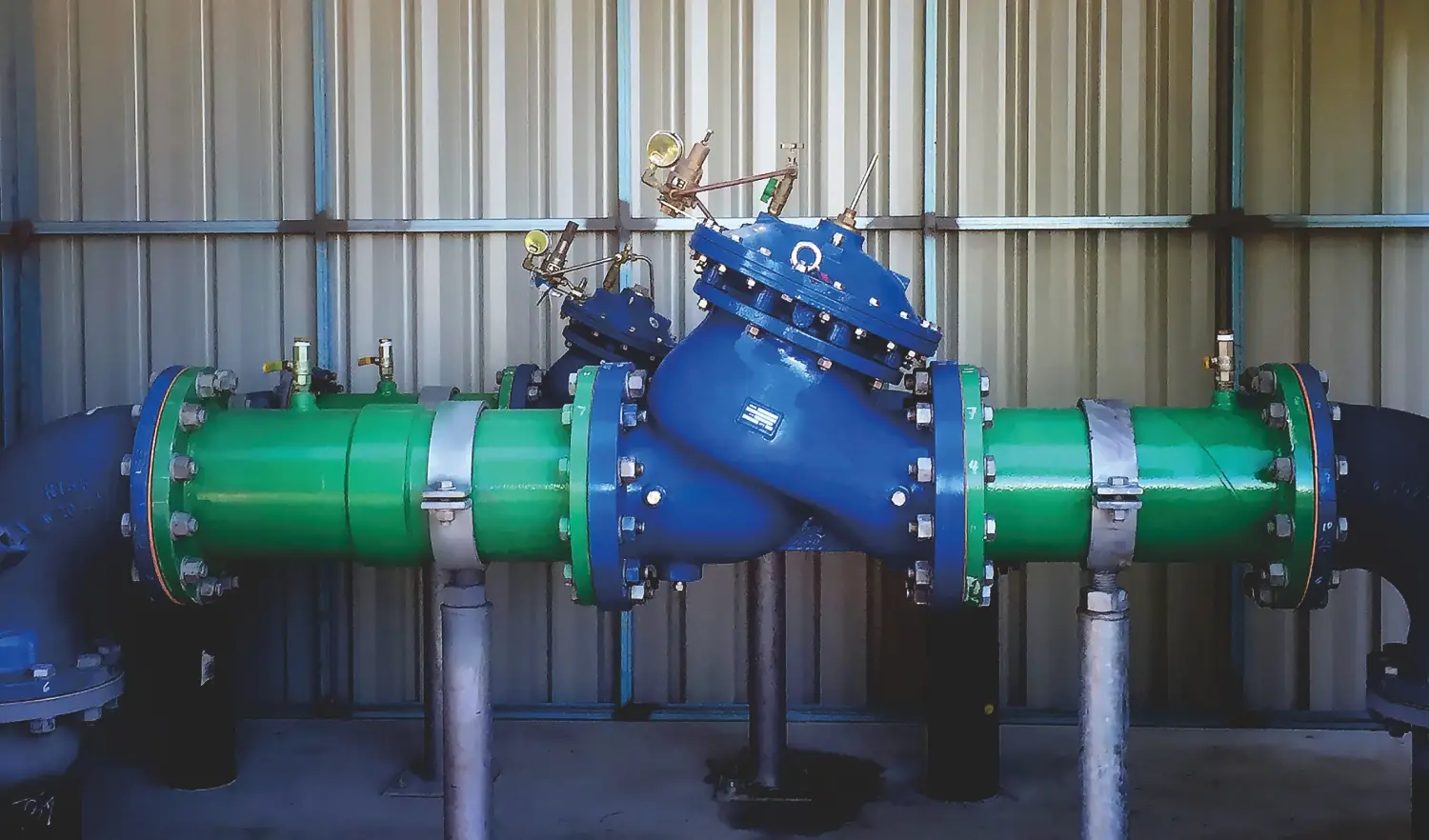 green and blue industrial pipe assembly