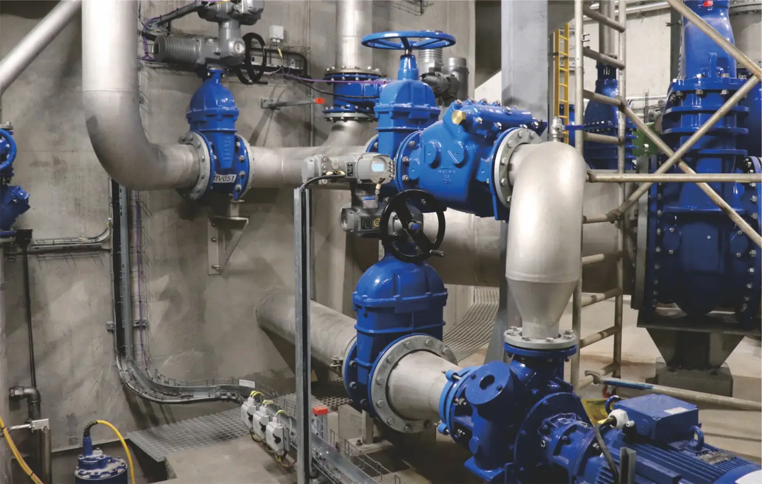 industrial pipe network with blue control valves and actuators