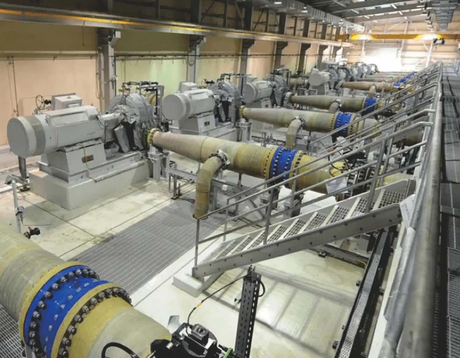 row of large industrial pumps with insulation